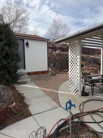a view of a backyard with table and chairs