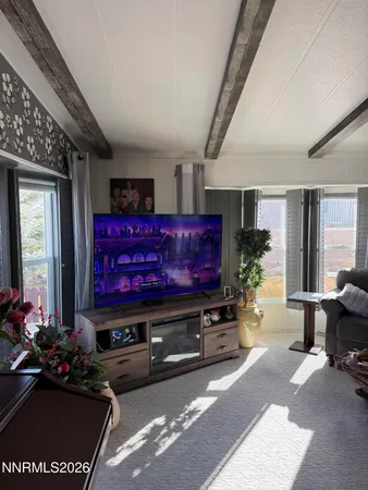 a living room with furniture a flowers and a window
