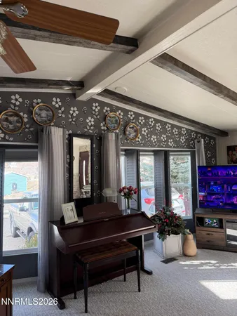 a living room with furniture a chandelier and a piano