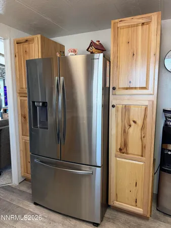 a metallic refrigerator freezer sitting in a kitchen