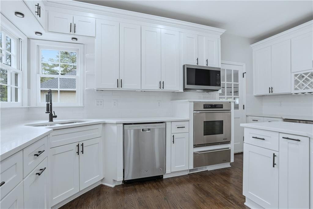 2800 Lakewind Court Alpharetta, GA 30005 - Photo 11 of 26 a kitchen with white cabinets and white appliances