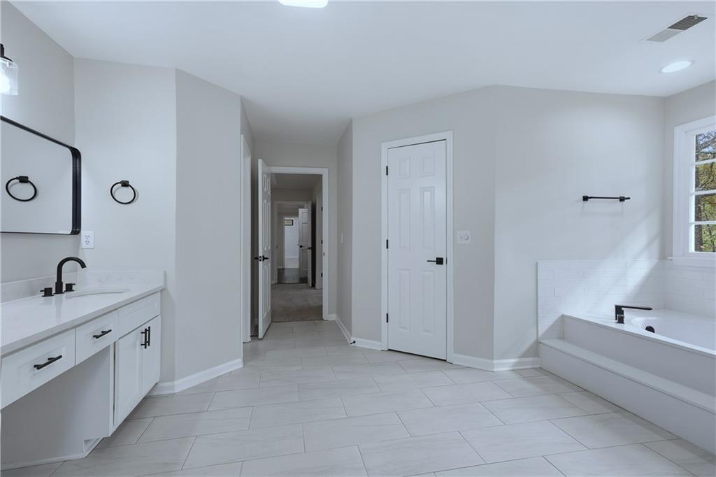 2800 Lakewind Court Alpharetta, GA 30005 - Photo 18 of 26 a bathroom with a tub sink and mirror