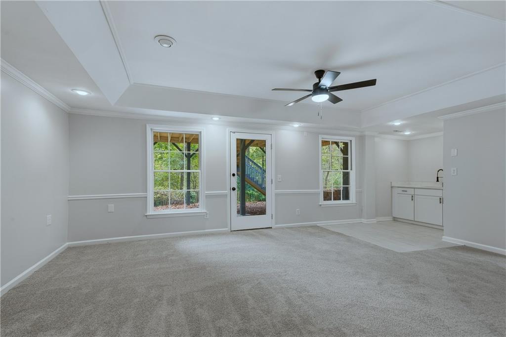 2800 Lakewind Court Alpharetta, GA 30005 - Photo 20 of 26 a view of a livingroom with a ceiling fan and window