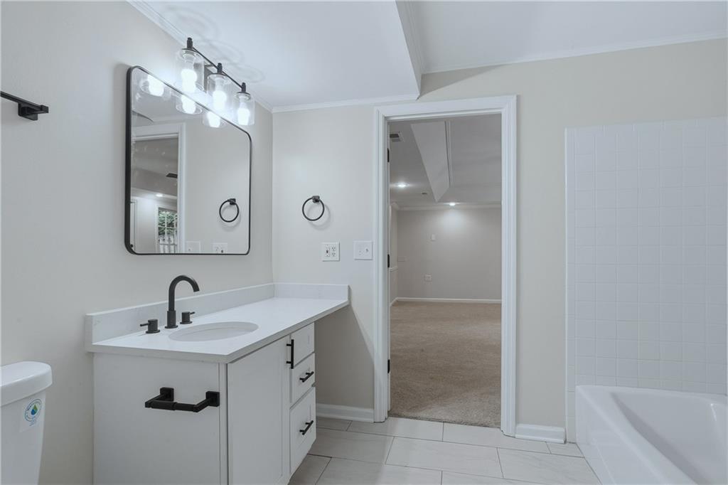 2800 Lakewind Court Alpharetta, GA 30005 - Photo 24 of 26 a bathroom with a sink and a mirror