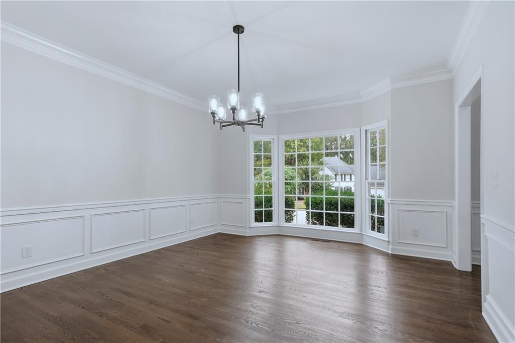 2800 Lakewind Court Alpharetta, GA 30005 - Photo 4 of 26 a view of an empty room with wooden floor and a window