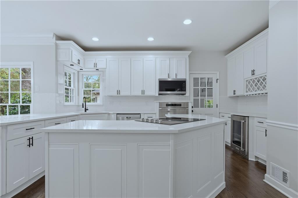 2800 Lakewind Court Alpharetta, GA 30005 - Photo 9 of 26 a kitchen with stainless steel appliances granite countertop a sink a stove a refrigerator cabinets and a window