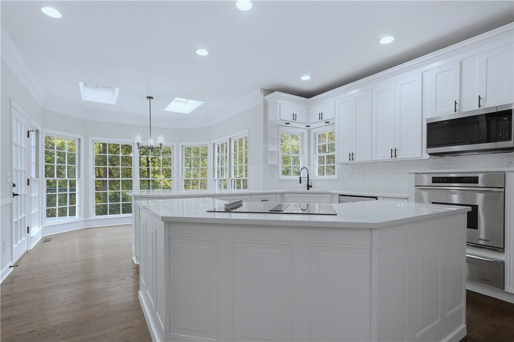 2800 Lakewind Court Alpharetta, GA 30005 - Photo 10 of 26 a kitchen with stainless steel appliances granite countertop a sink and a stove