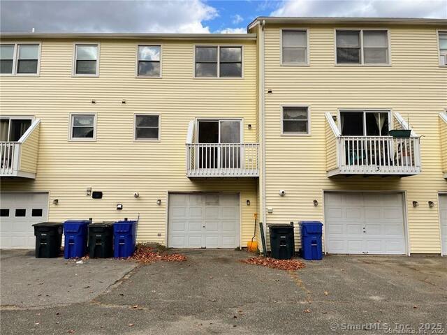 77 Marion Avenue, Unit 2 Torrington, CT 06790 - Photo 28 of 35 a view of a brick house with many windows