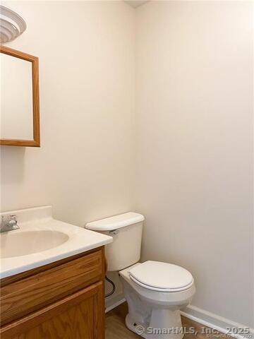 77 Marion Avenue, Unit 2 Torrington, CT 06790 - Photo 30 of 35 a white toilet sitting next to a bathroom sink
