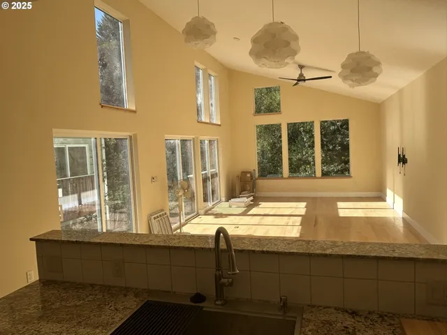 a bathroom with a granite countertop sink and a window