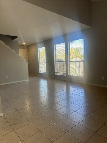 an empty room with large windows