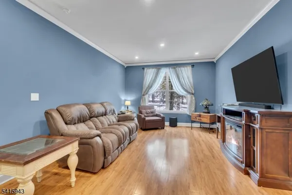 a view of a hallway with wooden floor and stairs