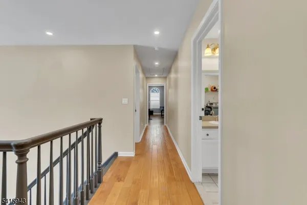 a bathroom with a sink double vanity granite tub toilet and a mirror