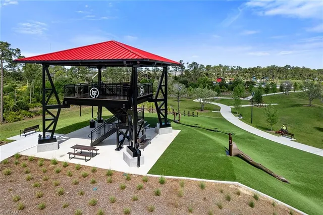 a view of a swimming pool and lounge chairs in the patio