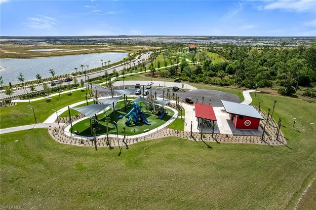 a view of a swimming pool with lawn chairs under an umbrella