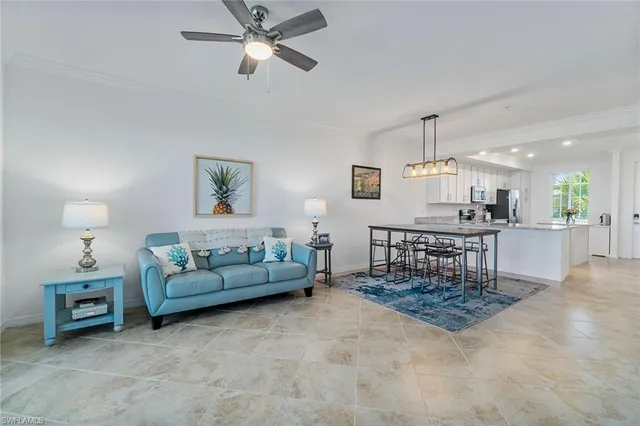 a living room with furniture and kitchen view