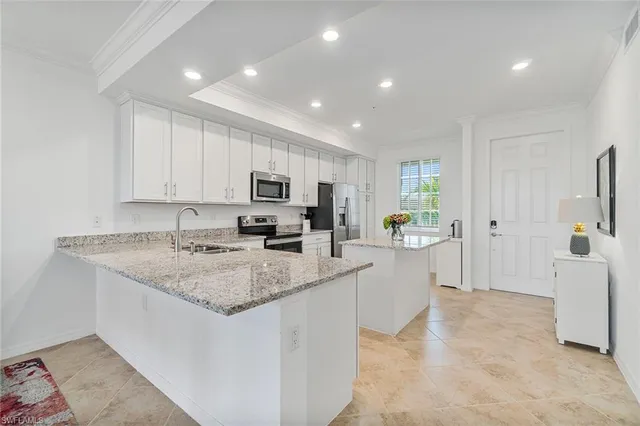 a view of kitchen with sink microwave and refrigerator
