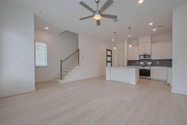 a kitchen with stainless steel appliances white cabinets and a sink