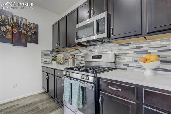 a kitchen with stainless steel appliances granite countertop a stove and a microwave