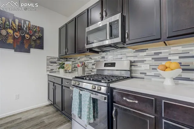 a kitchen with stainless steel appliances granite countertop a stove and a microwave