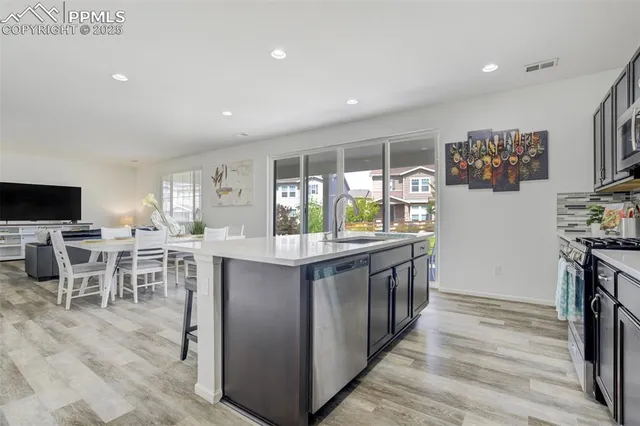 a kitchen with stainless steel appliances granite countertop lots of counter top space and furniture