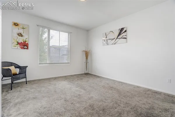 an empty room with windows and cabinet