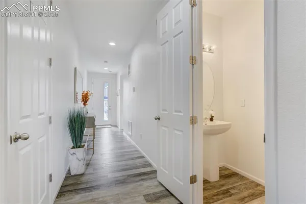 a view of a hallway with wooden floor and staircase