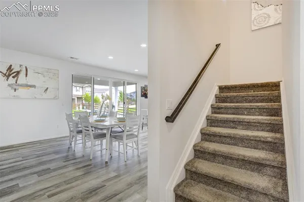 a view of entryway and hall with wooden floor