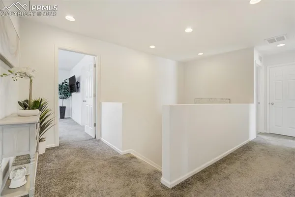 a view of a hallway view with staircase