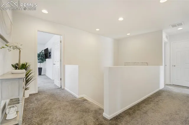 a view of a hallway view with staircase