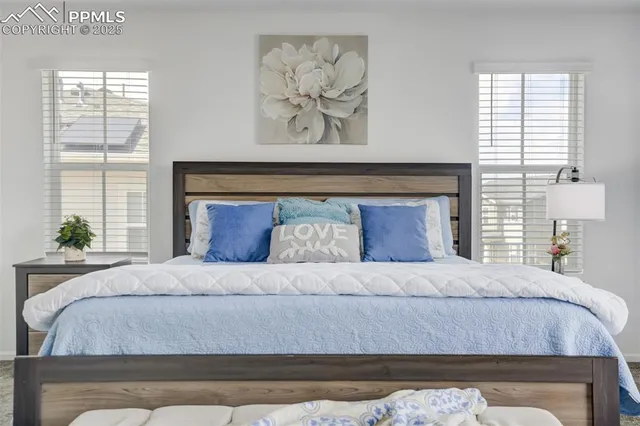 a bedroom with a bed and a painting on the wall