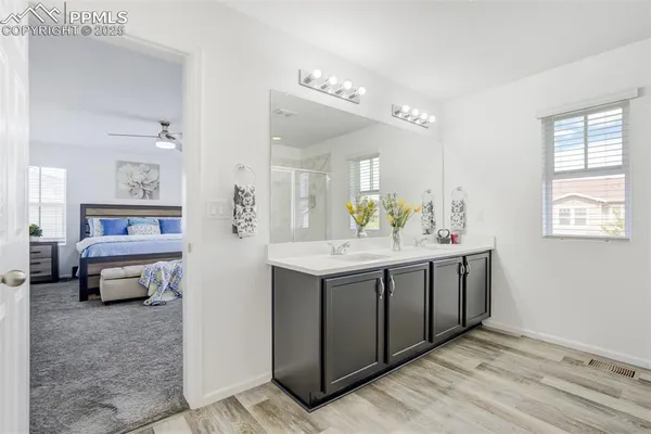 a bathroom with a sink a vanity and a mirror