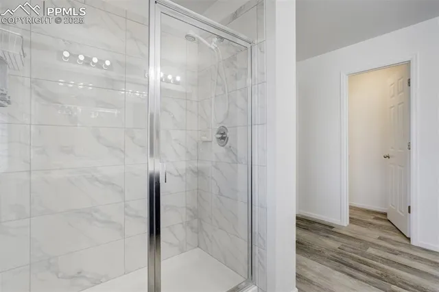 a bathroom with a glass shower door
