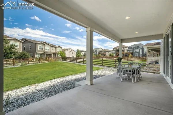 a view of a porch with furniture and garden