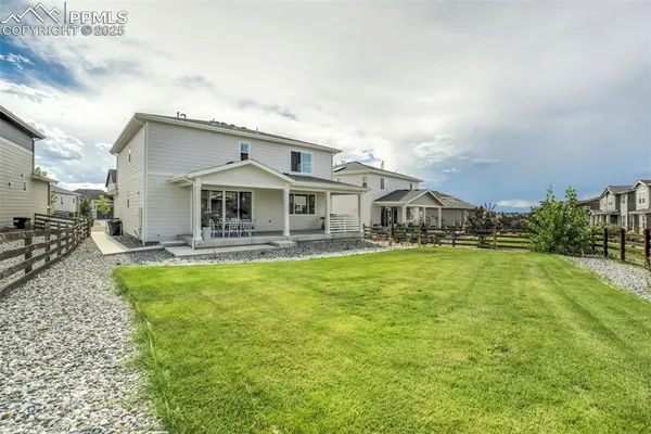 a front view of house with yard and swimming pool