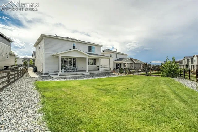 a front view of house with yard and swimming pool