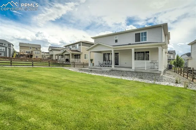 a front view of a house with a yard table and chairs