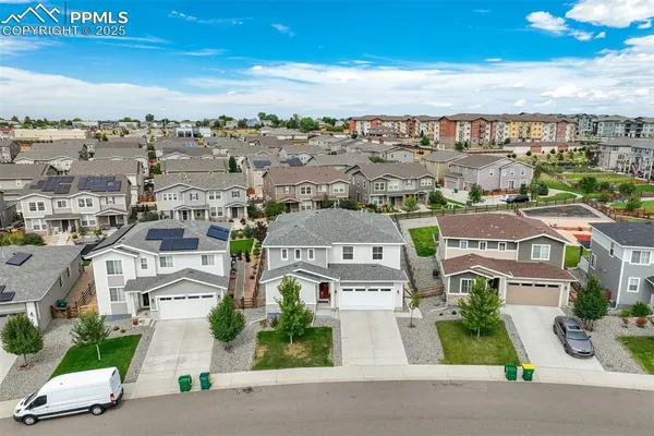 an aerial view of residential houses with city view