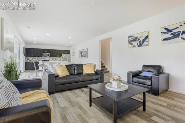 a living room with furniture and wooden floor