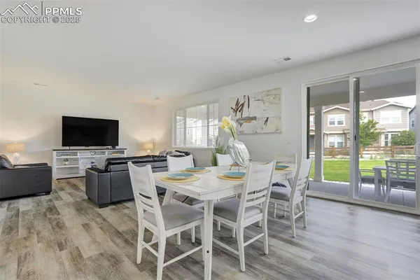 a view of a dining room with furniture window and wooden floor
