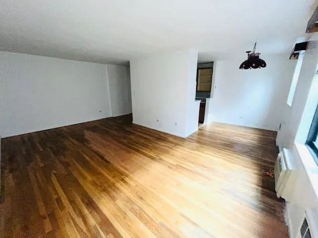a view of a room with wooden floor and bathroom