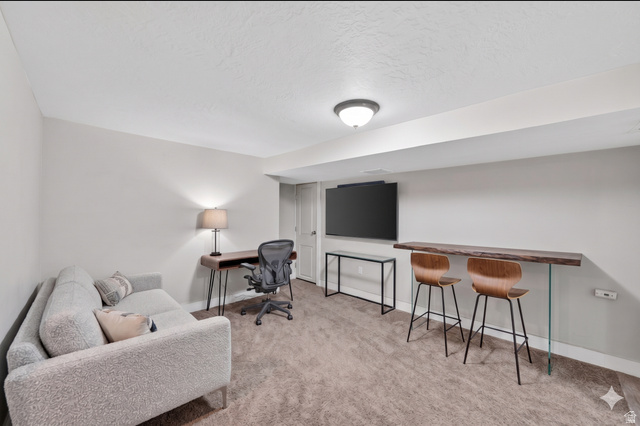 7879 Oak Street Midvale, UT 84047 - Photo 19 of 32 Finished basement featuring light gray walls, recessed lighting, and a built-in wood-finish bar top with clear supports