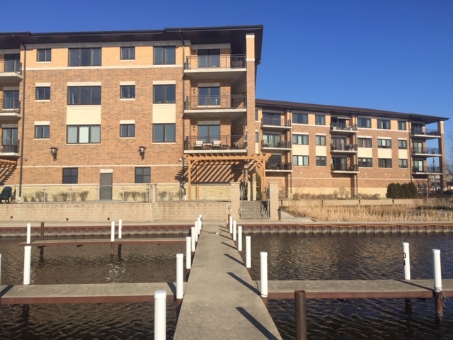 728 North Diamond Lake Road, Unit 205 Mundelein, IL 60060 - Photo 3 of 19 a front view of a building with glass windows