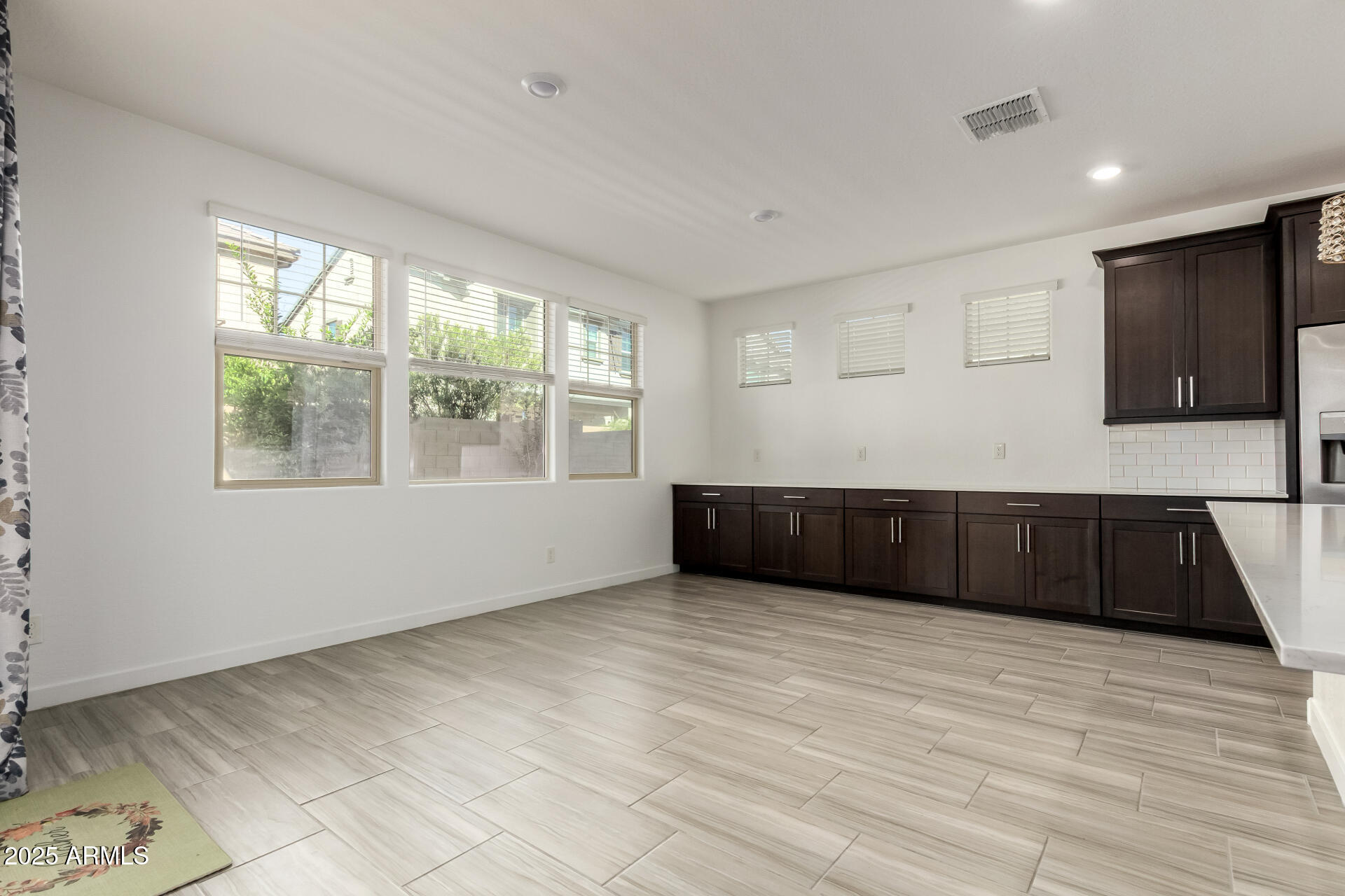 1156 East Weatherby Way Chandler, AZ 85286 - Photo 12 of 47 a view of an empty room with a window and wooden floor