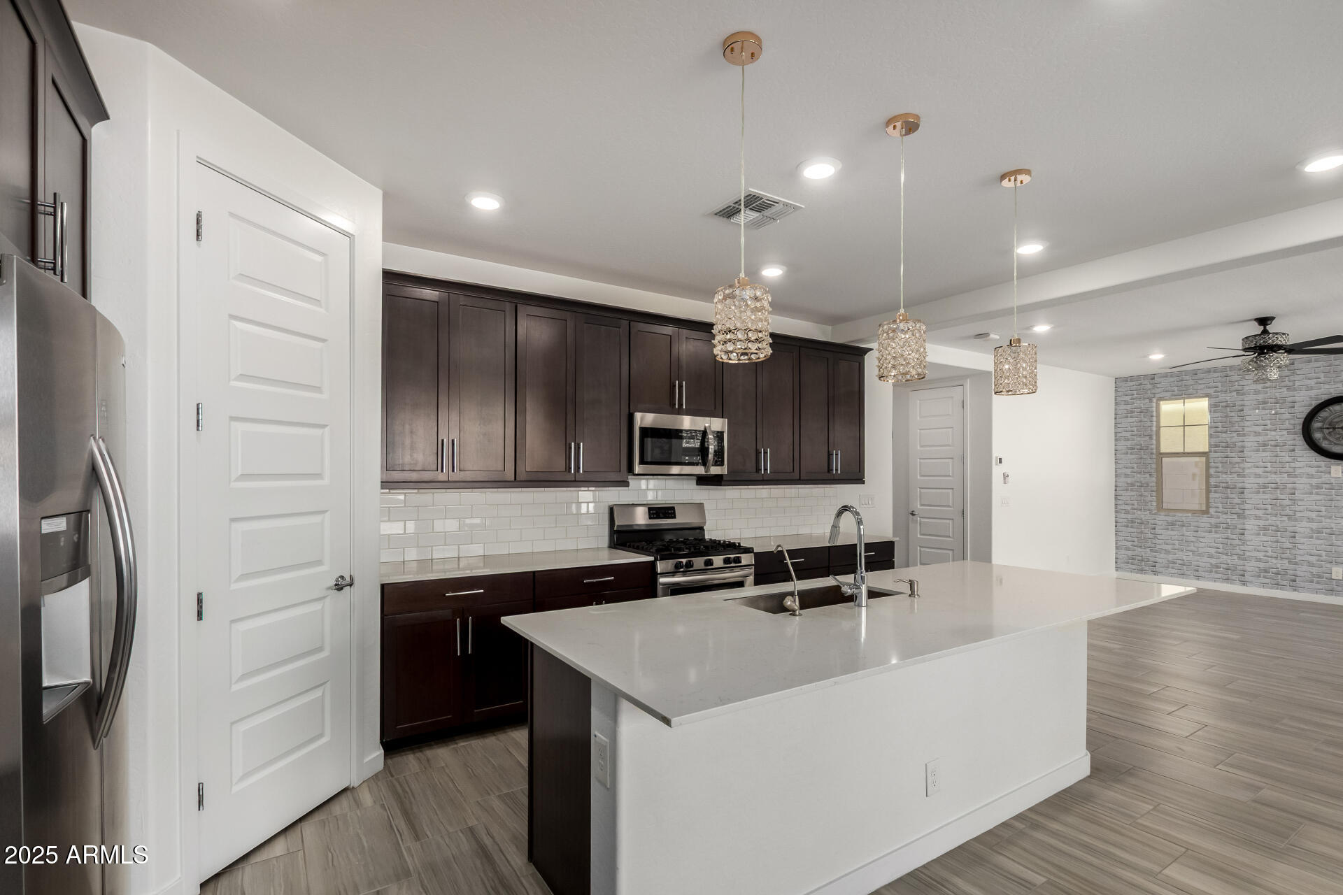 1156 East Weatherby Way Chandler, AZ 85286 - Photo 14 of 47 a kitchen with a sink stainless steel appliances and cabinets