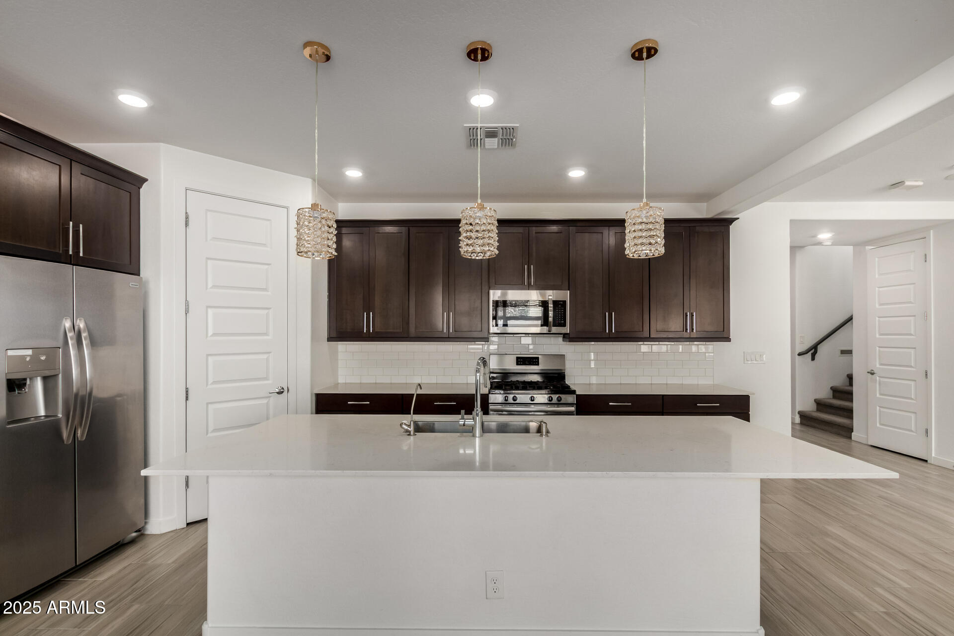1156 East Weatherby Way Chandler, AZ 85286 - Photo 15 of 47 a kitchen with stainless steel appliances kitchen island a sink and a stove