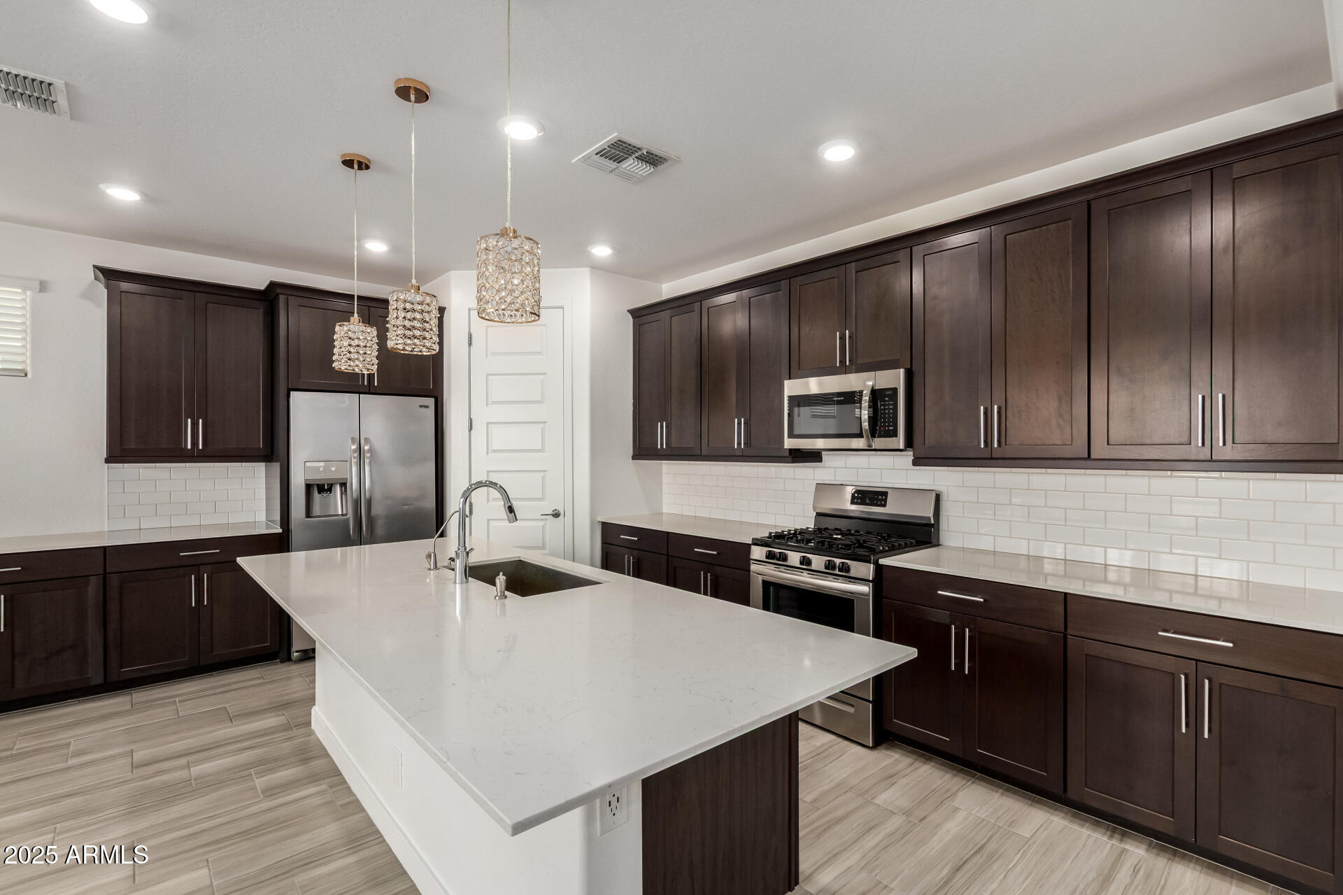 1156 East Weatherby Way Chandler, AZ 85286 - Photo 16 of 47 a kitchen with kitchen island granite countertop stainless steel appliances cabinets a sink and a counter top space