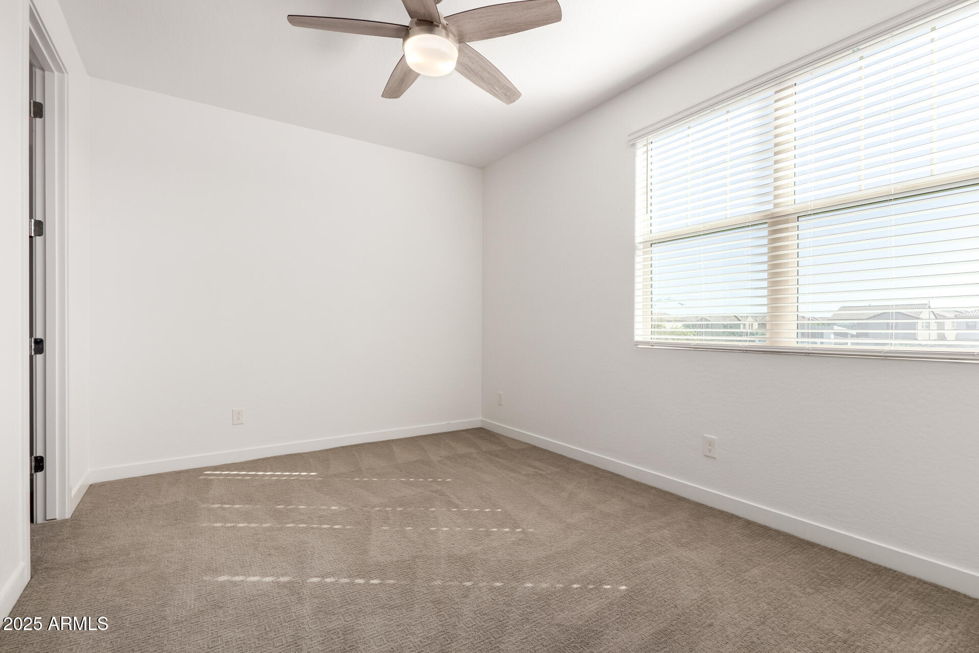 1156 East Weatherby Way Chandler, AZ 85286 - Photo 33 of 47 an empty room with a window and a fan