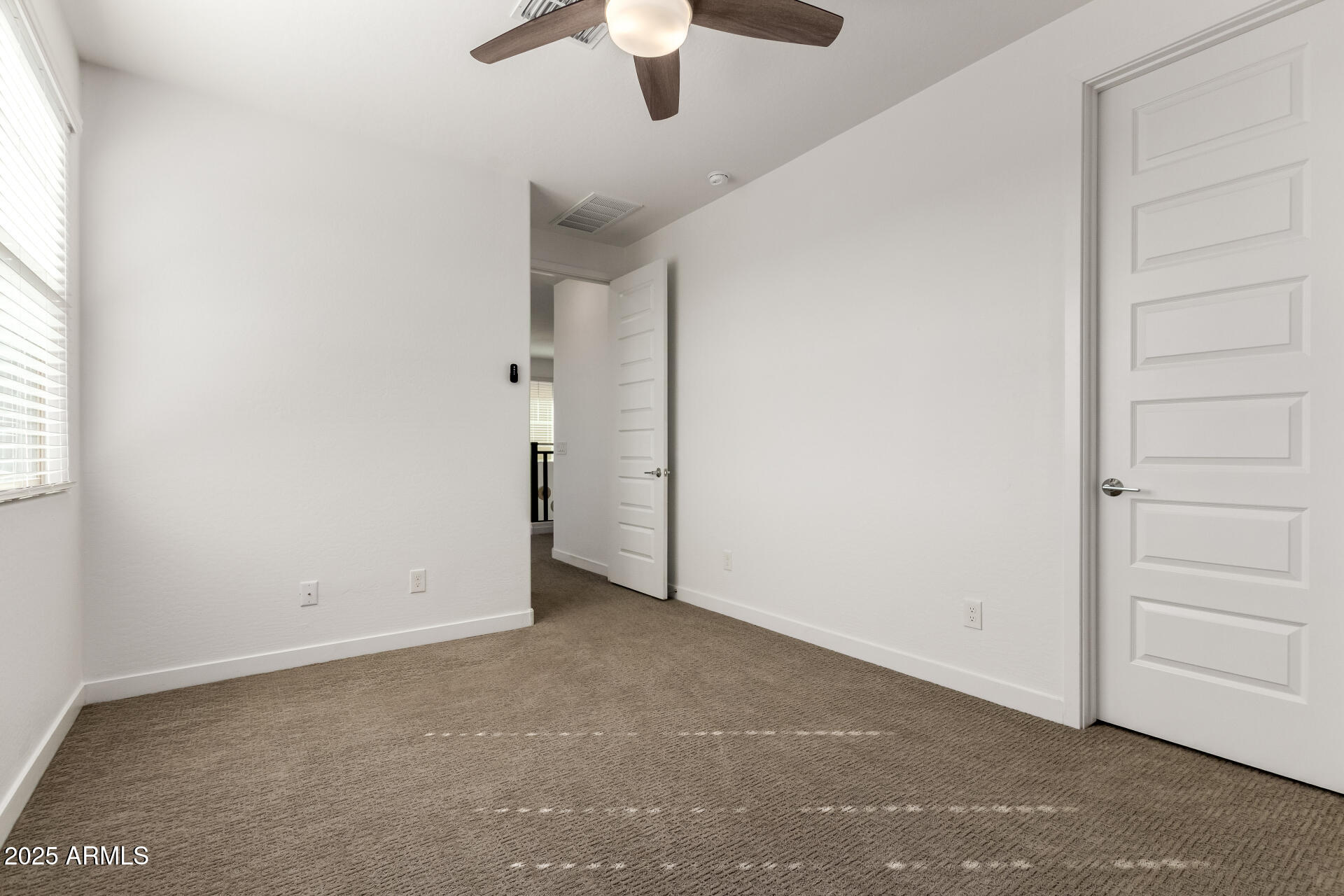 1156 East Weatherby Way Chandler, AZ 85286 - Photo 34 of 47 an empty room with a ceiling fan and window