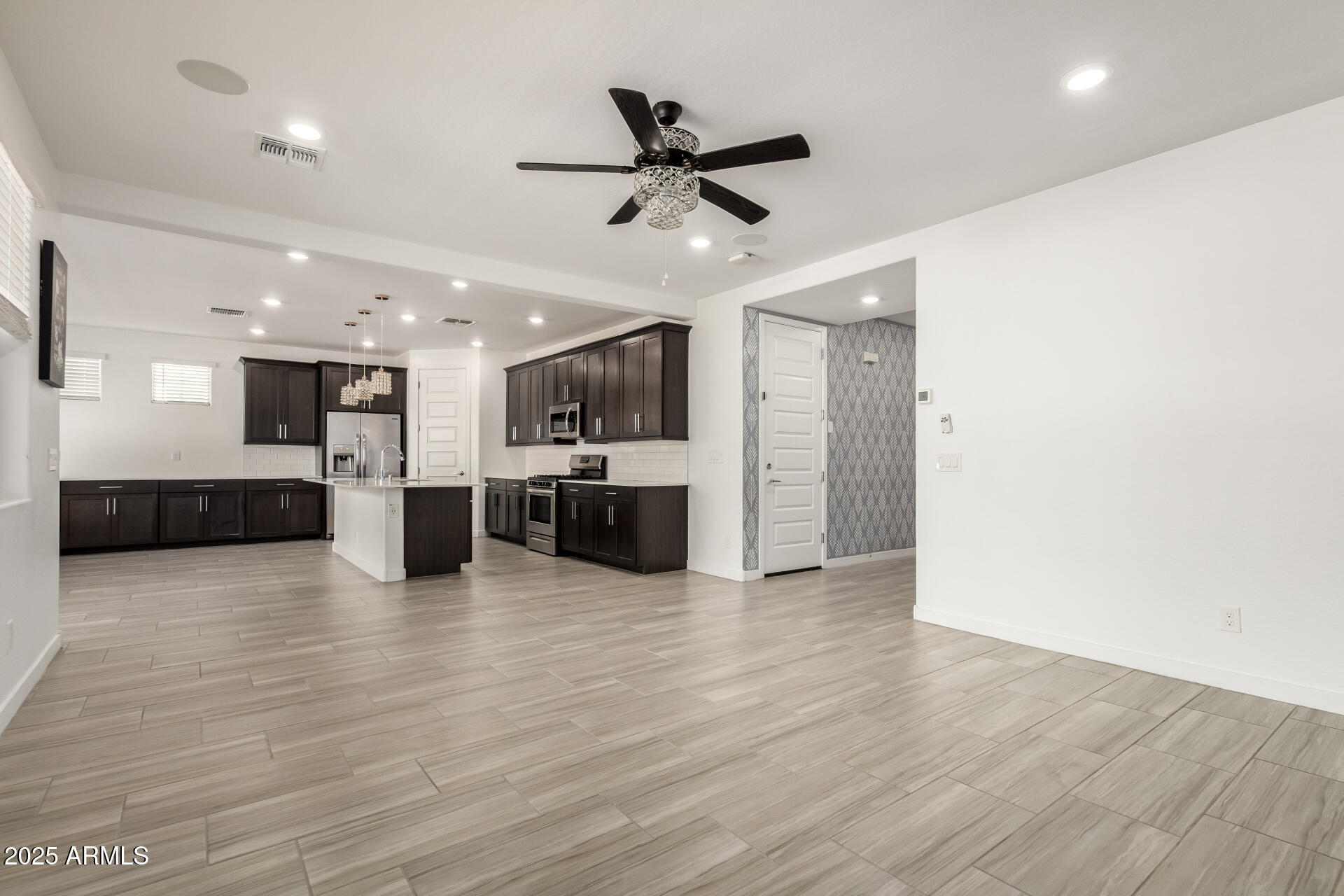 1156 East Weatherby Way Chandler, AZ 85286 - Photo 10 of 47 a view of an empty room with kitchen appliances and a ceiling fan